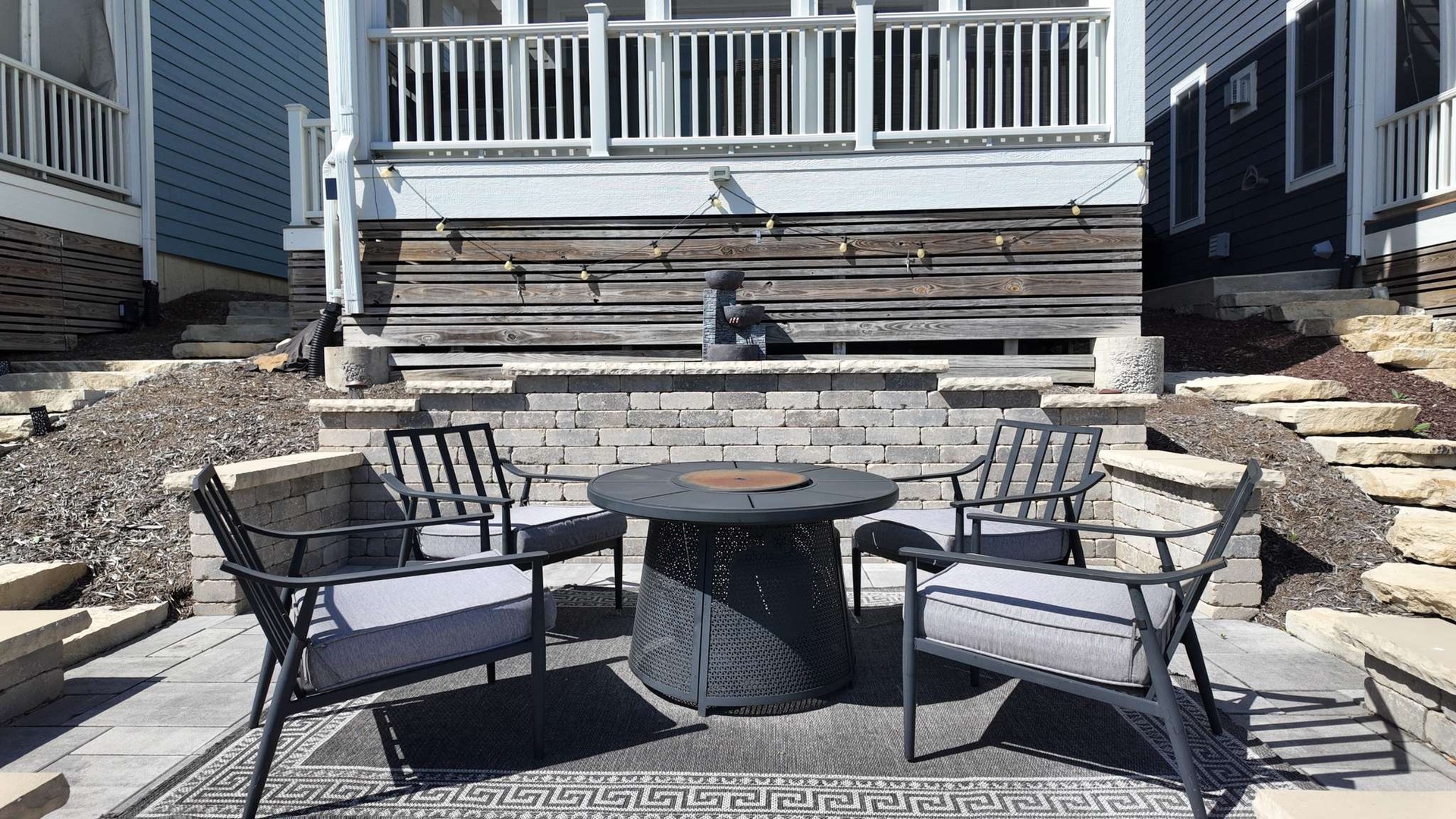 Gather around your private fire pit for cozy evenings under the stars, with comfortable seating and a stunning stone backdrop.