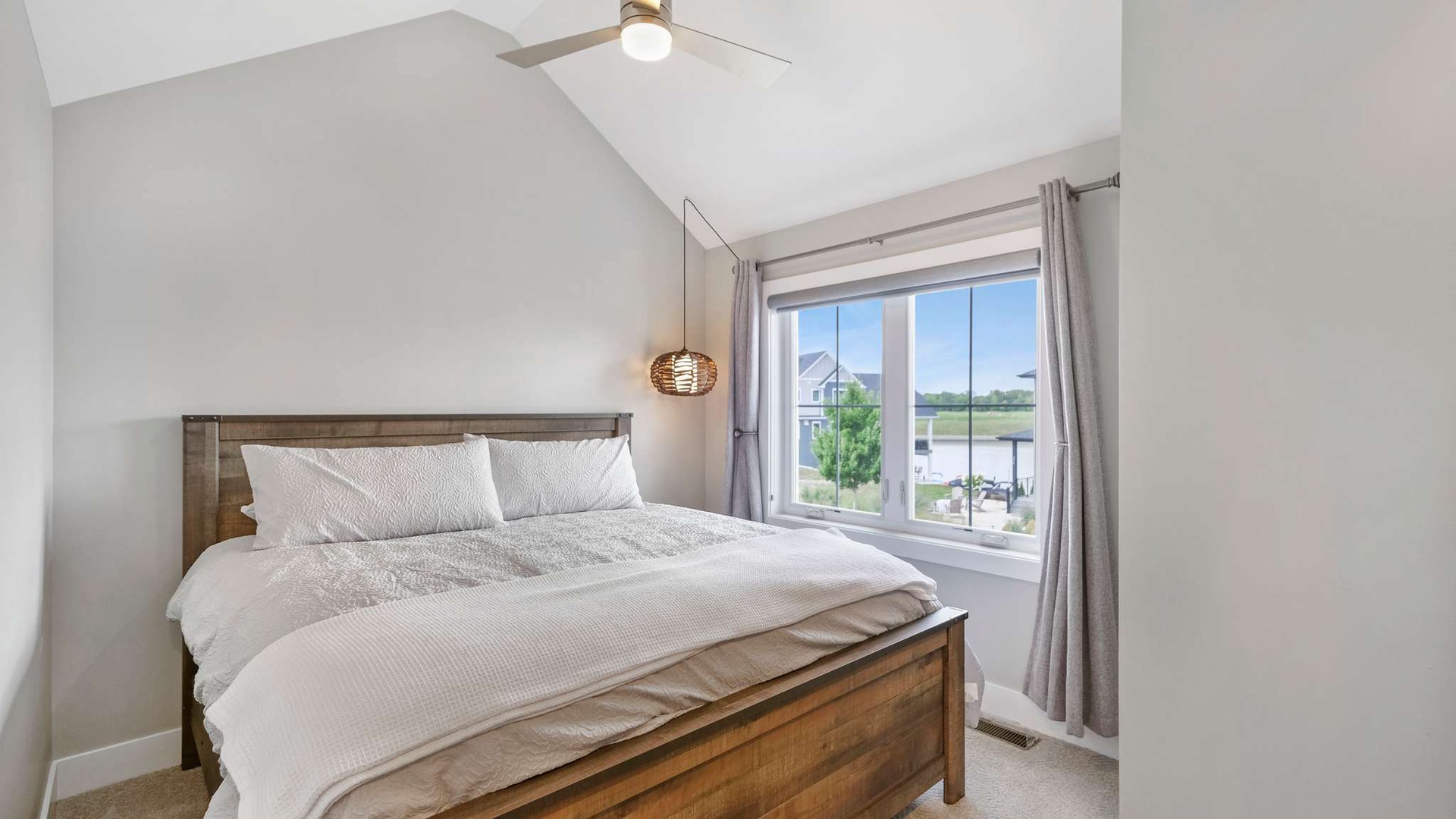 Wake up to serene lake views from your cozy bedroom, where crisp linens and gentle morning light create the perfect peaceful retreat.