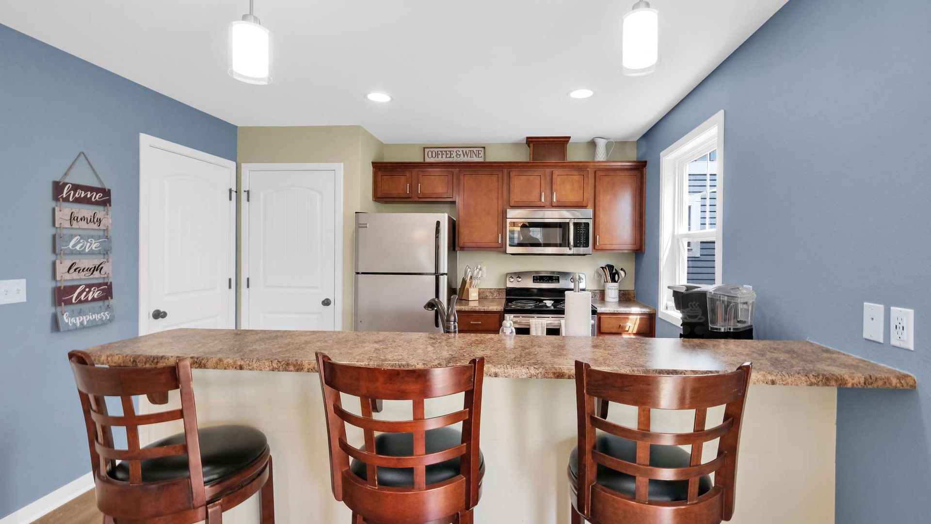 Your fully equipped kitchen features granite countertops, stainless steel appliances, and a breakfast bar where you can enjoy morning coffee.