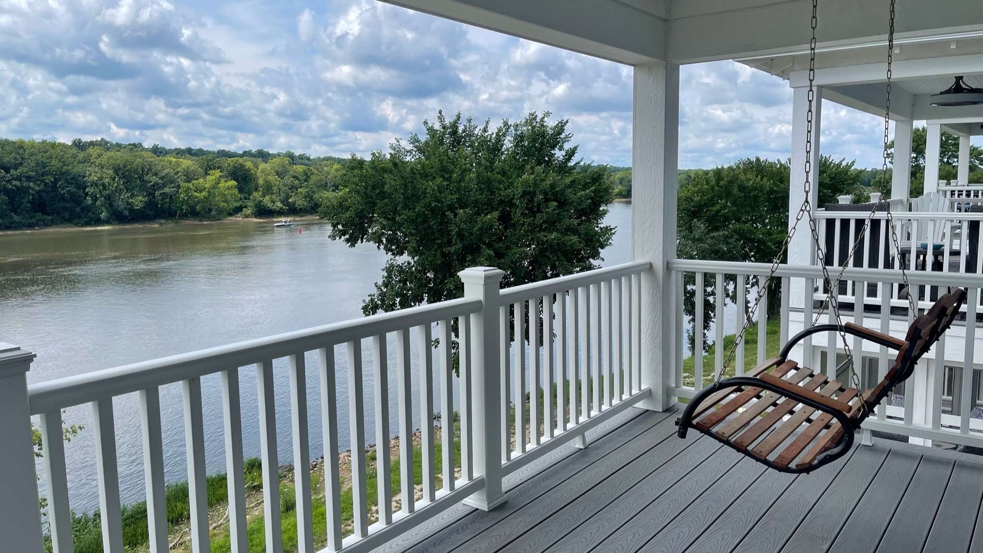 Sway gently in your private porch swing while watching boats drift by on the tranquil lake below.