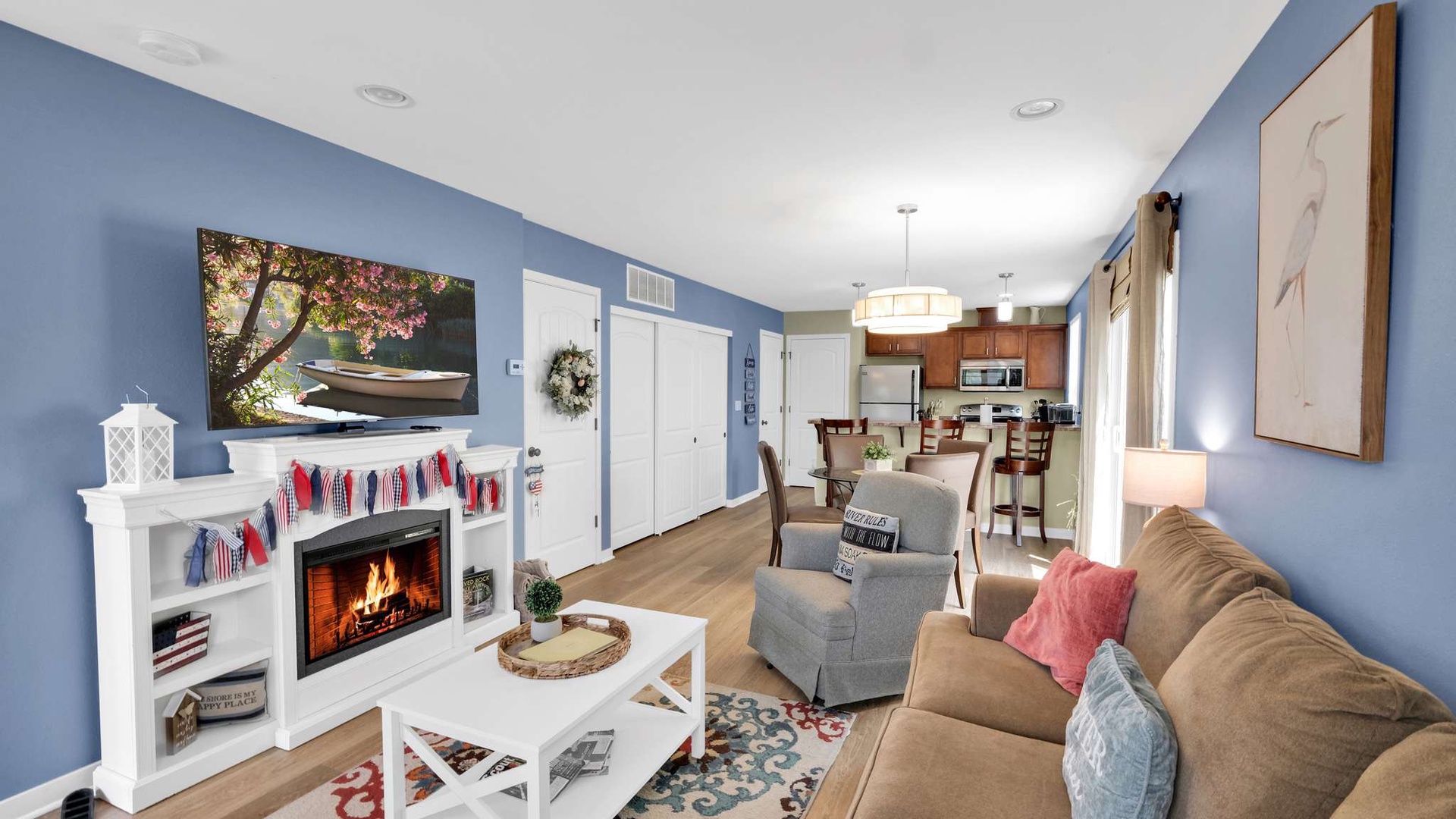 Settle into this cozy living space where blue walls and warm firelight create your perfect retreat after exploring.