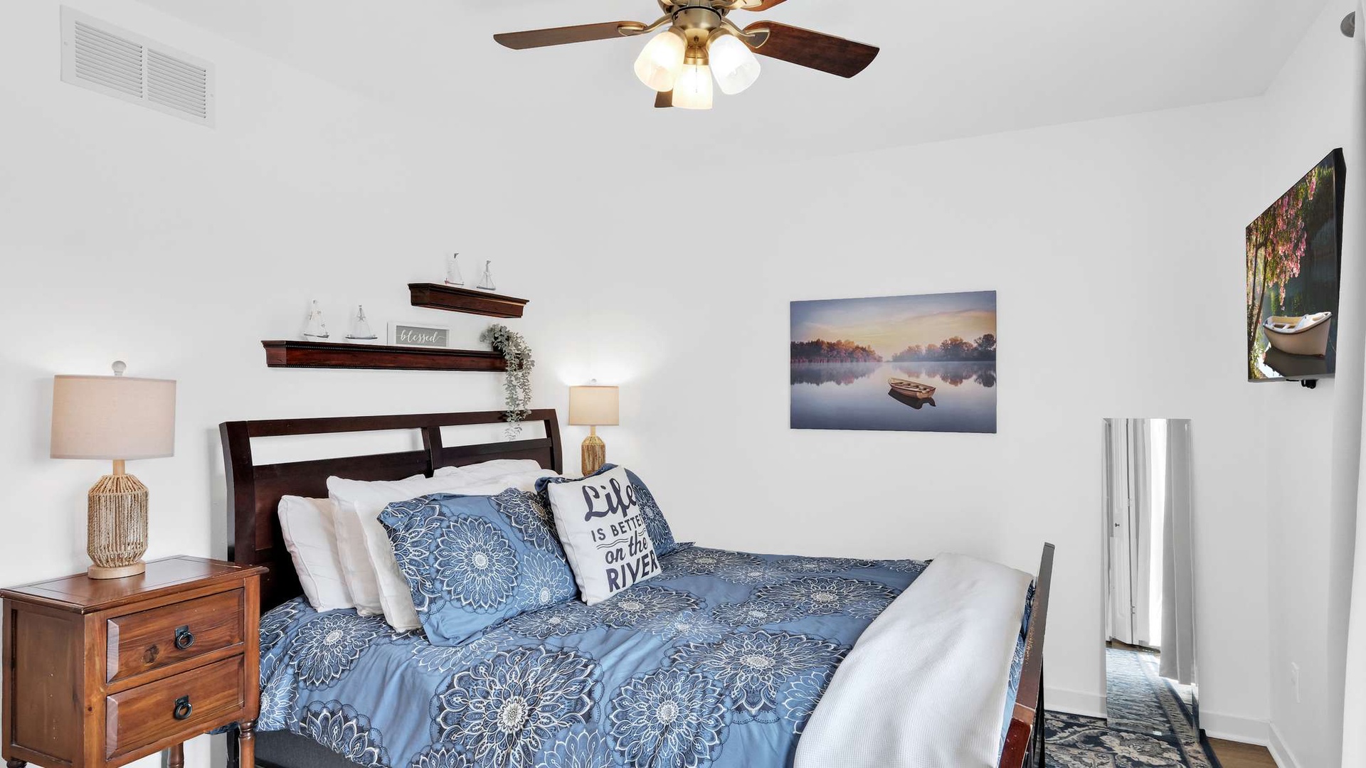 Drift off to sleep in your cozy bedroom, where crisp linens and peaceful lake artwork create the perfect retreat.