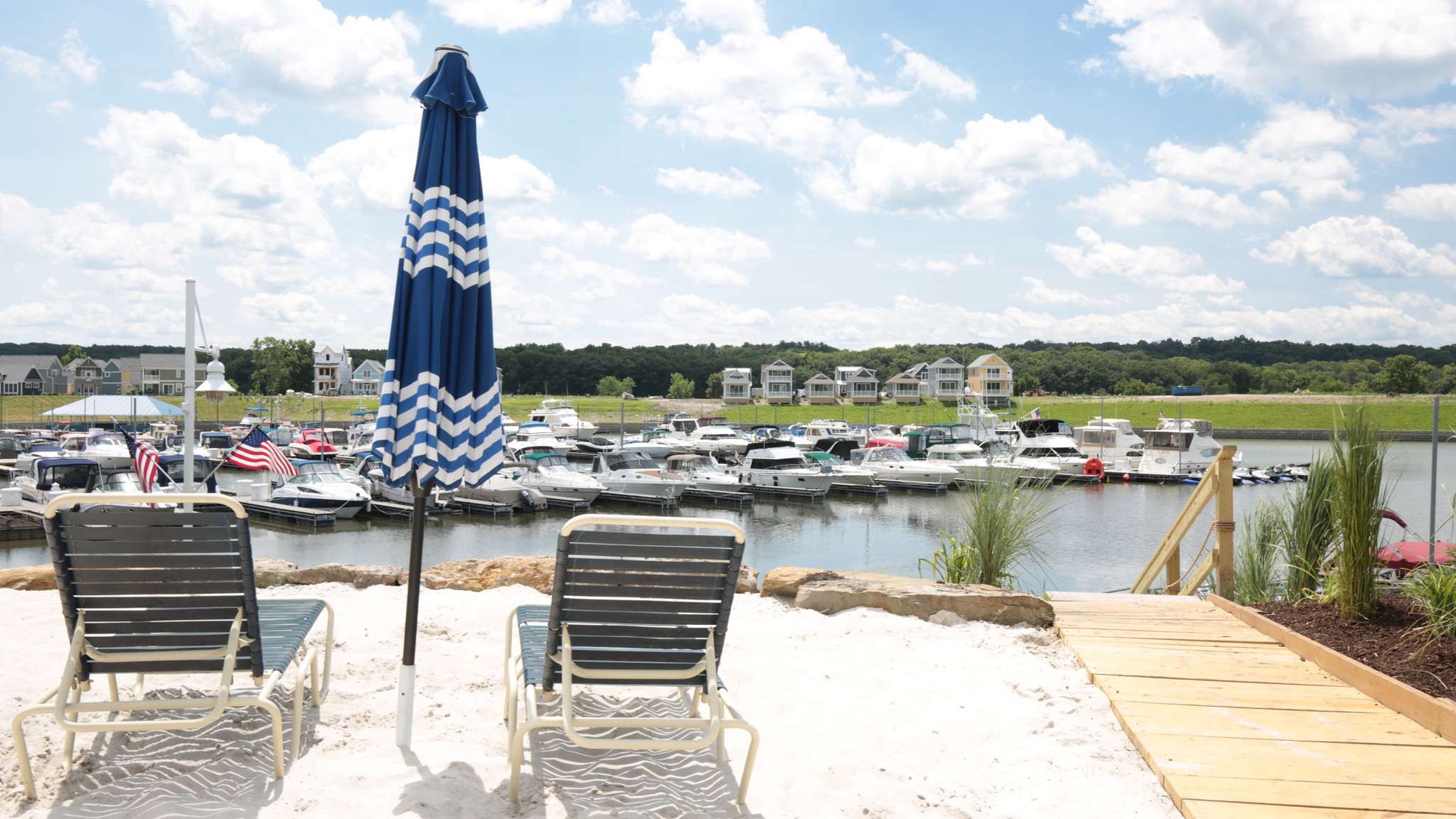 Your private beach area offers loungers and umbrella overlooking the peaceful marina, perfect for watching boats while you unwind.