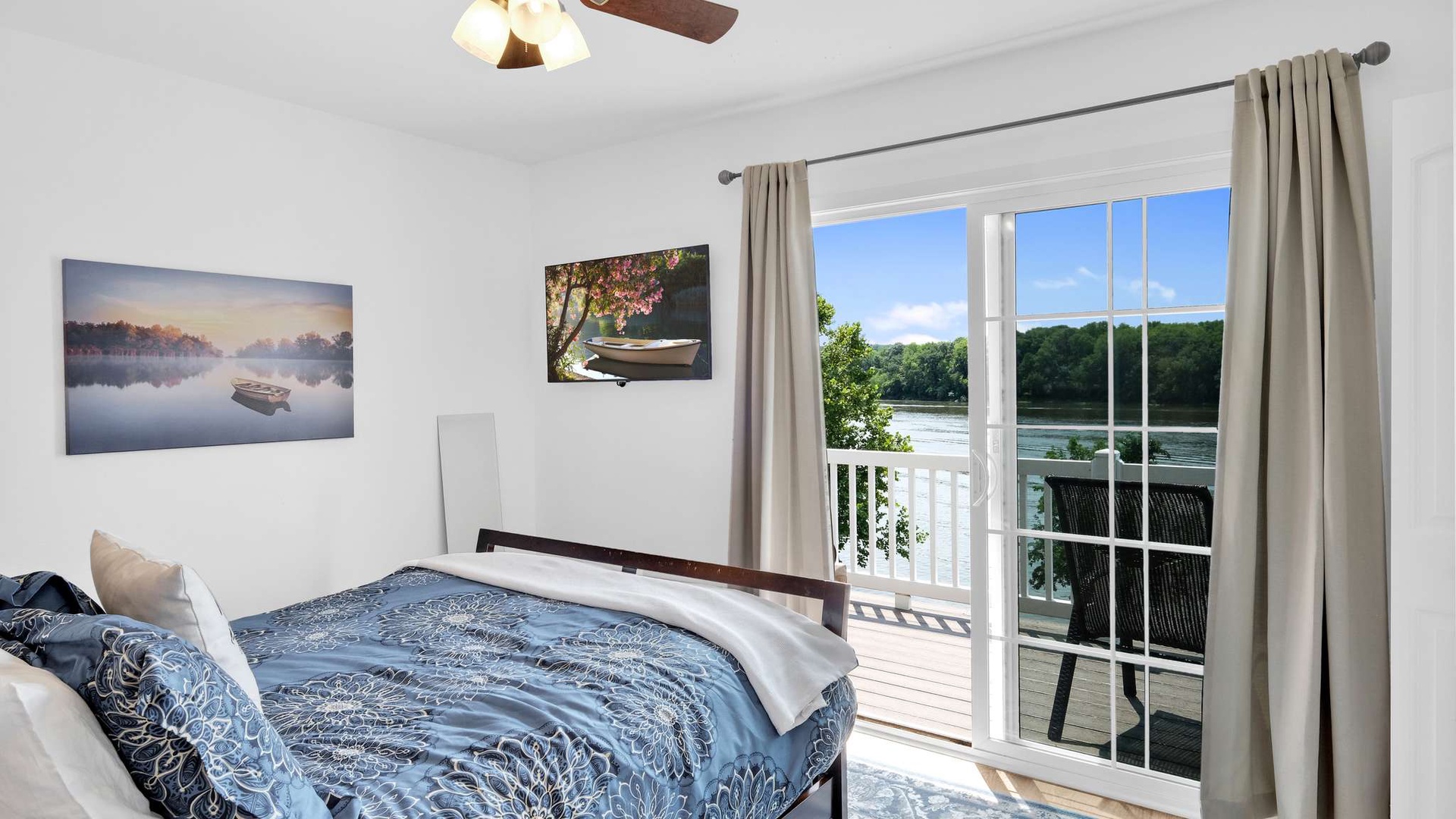 Wake up to stunning river views from your private balcony in this peaceful bedroom retreat.