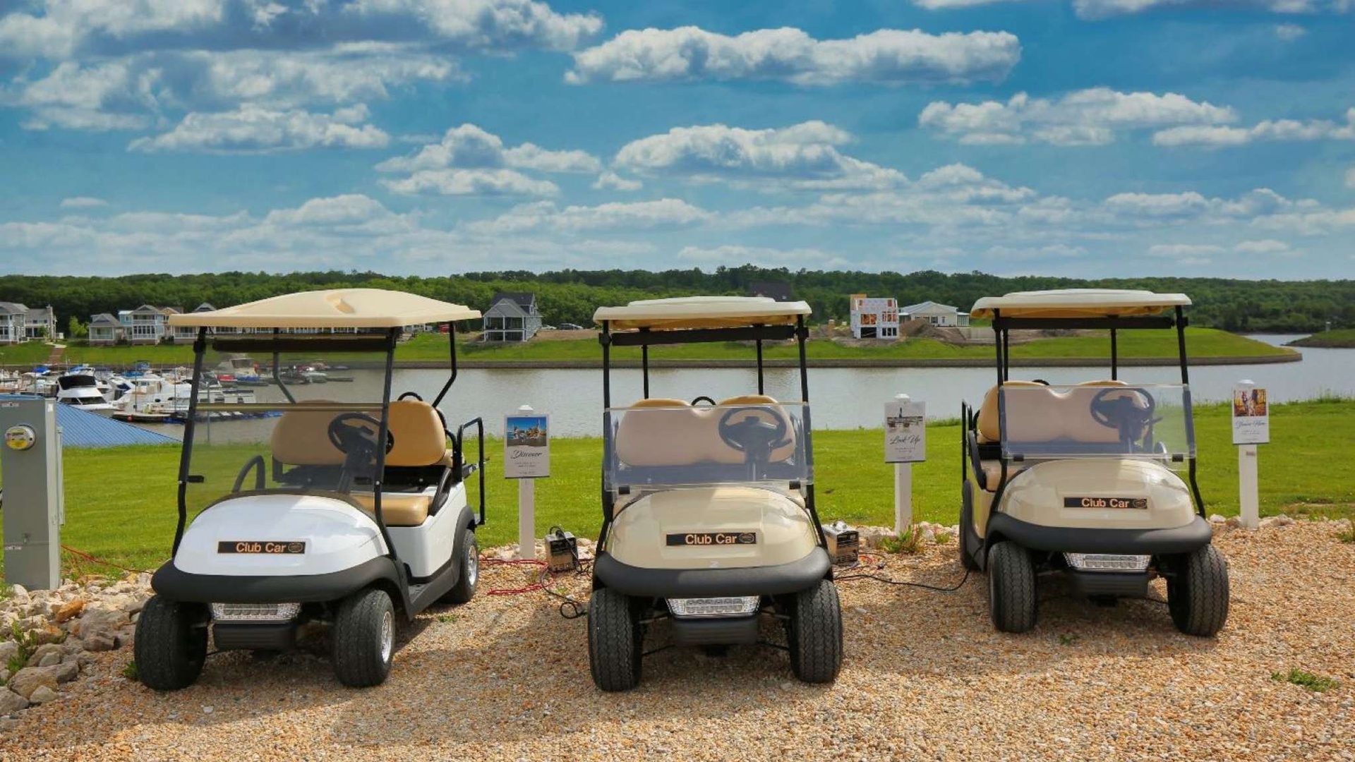 Golf carts parked near the waterfront, ready for exploring the scenic lakeside resort community.