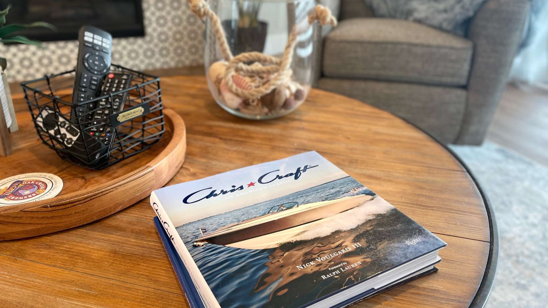 Settle into your comfortable living space with thoughtful touches like entertainment remote and inspiring coffee table books awaiting your downtime.