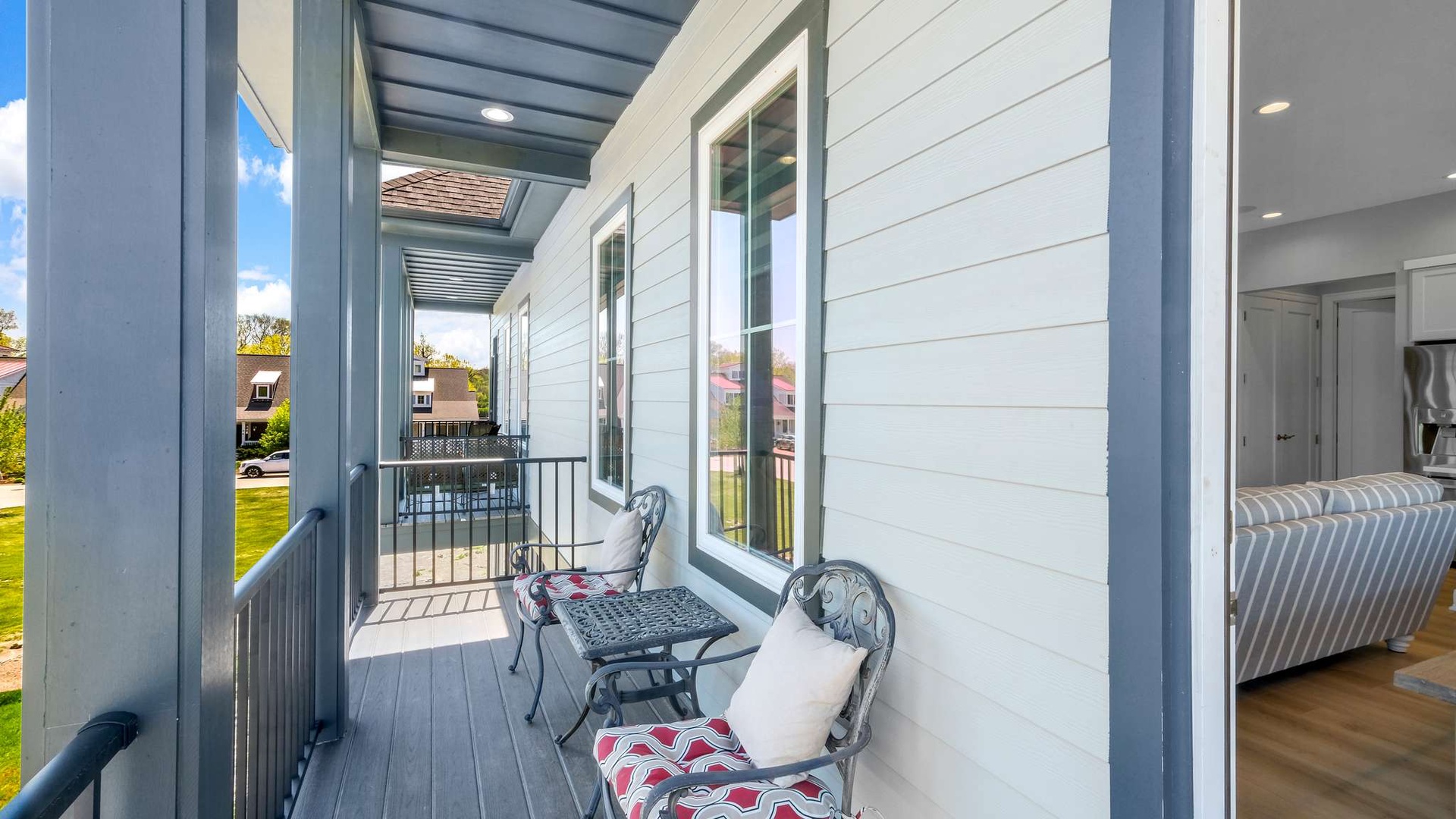 Step onto your private balcony and settle into charming bistro seating with decorative pillows, perfect for morning coffee or evening relaxation.