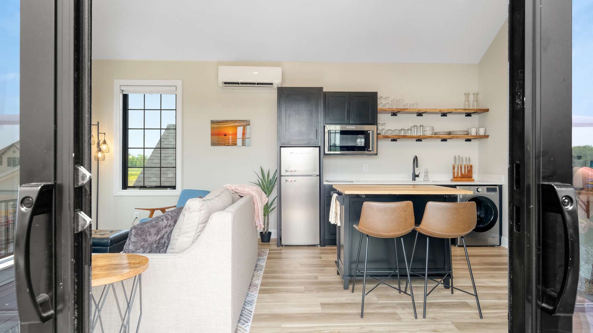 Your stylish open-concept space blends modern comfort with thoughtful design—relax on plush seating while enjoying the fully-equipped kitchen's sleek finishes.
