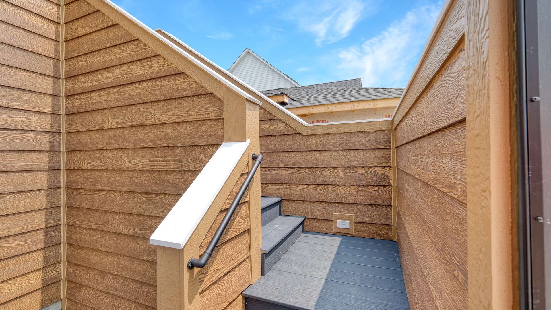 Step out onto your private rooftop terrace with warm wood walls and open sky views for peaceful moments.