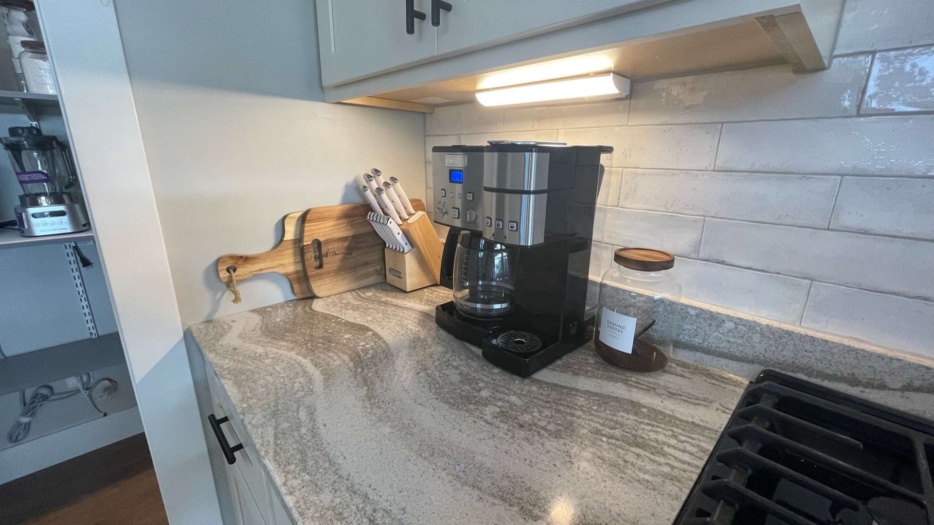 Your fully equipped kitchen awaits with granite counters, coffee maker, and quality knife set for easy meal prep.