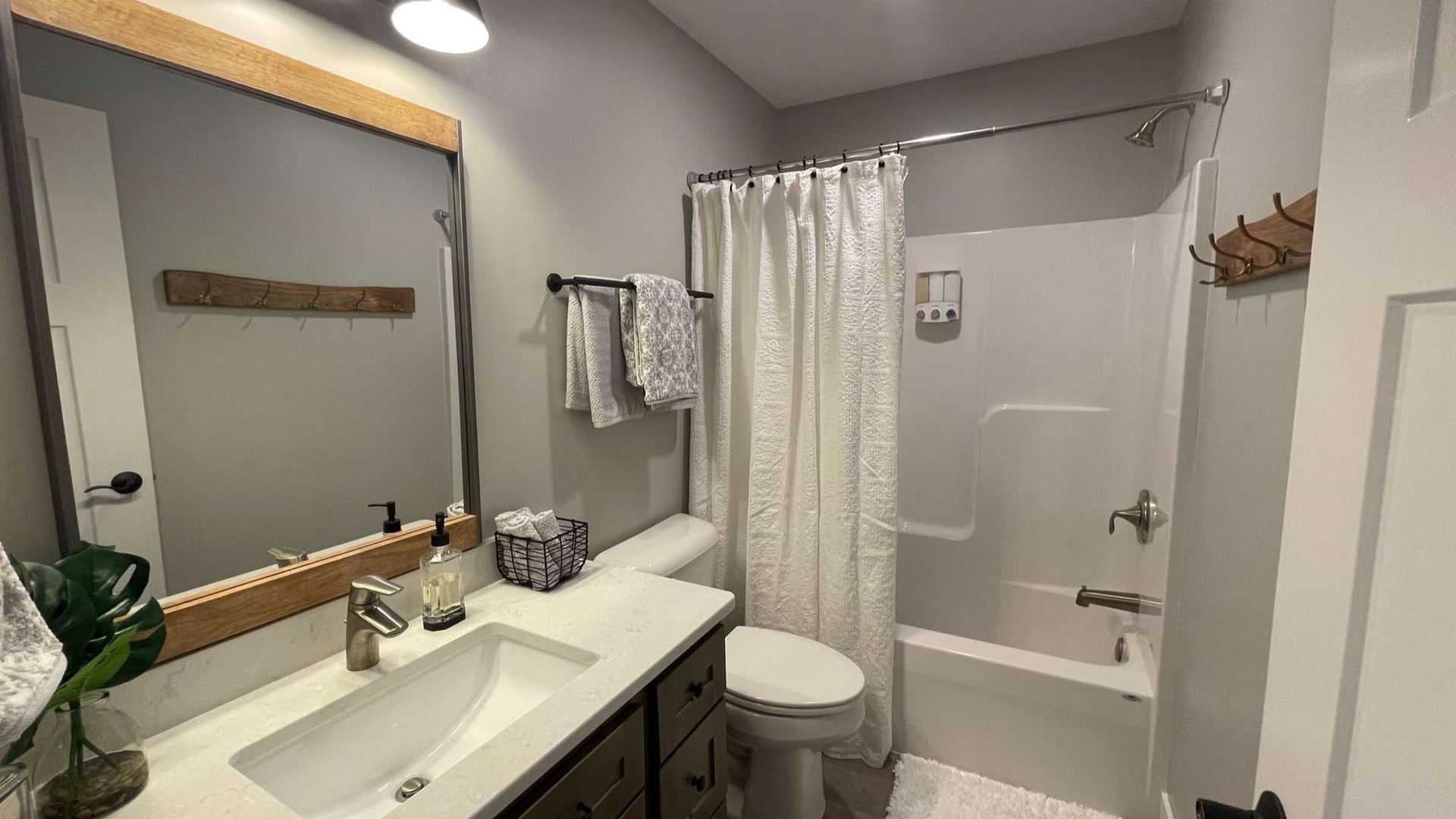 Step into your stylish bathroom with modern fixtures, plush towels, and a relaxing tub-shower combo perfect for unwinding after your adventures.