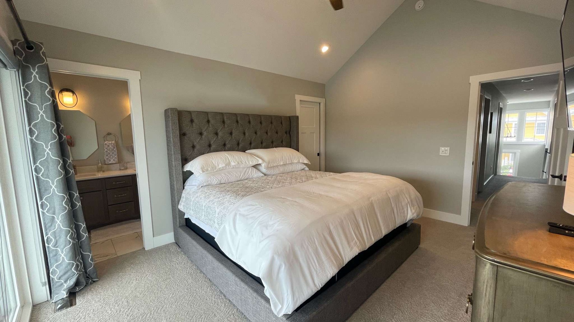 Sink into luxurious comfort in your private bedroom sanctuary, featuring a plush tufted headboard and crisp linens for the perfect night's rest.