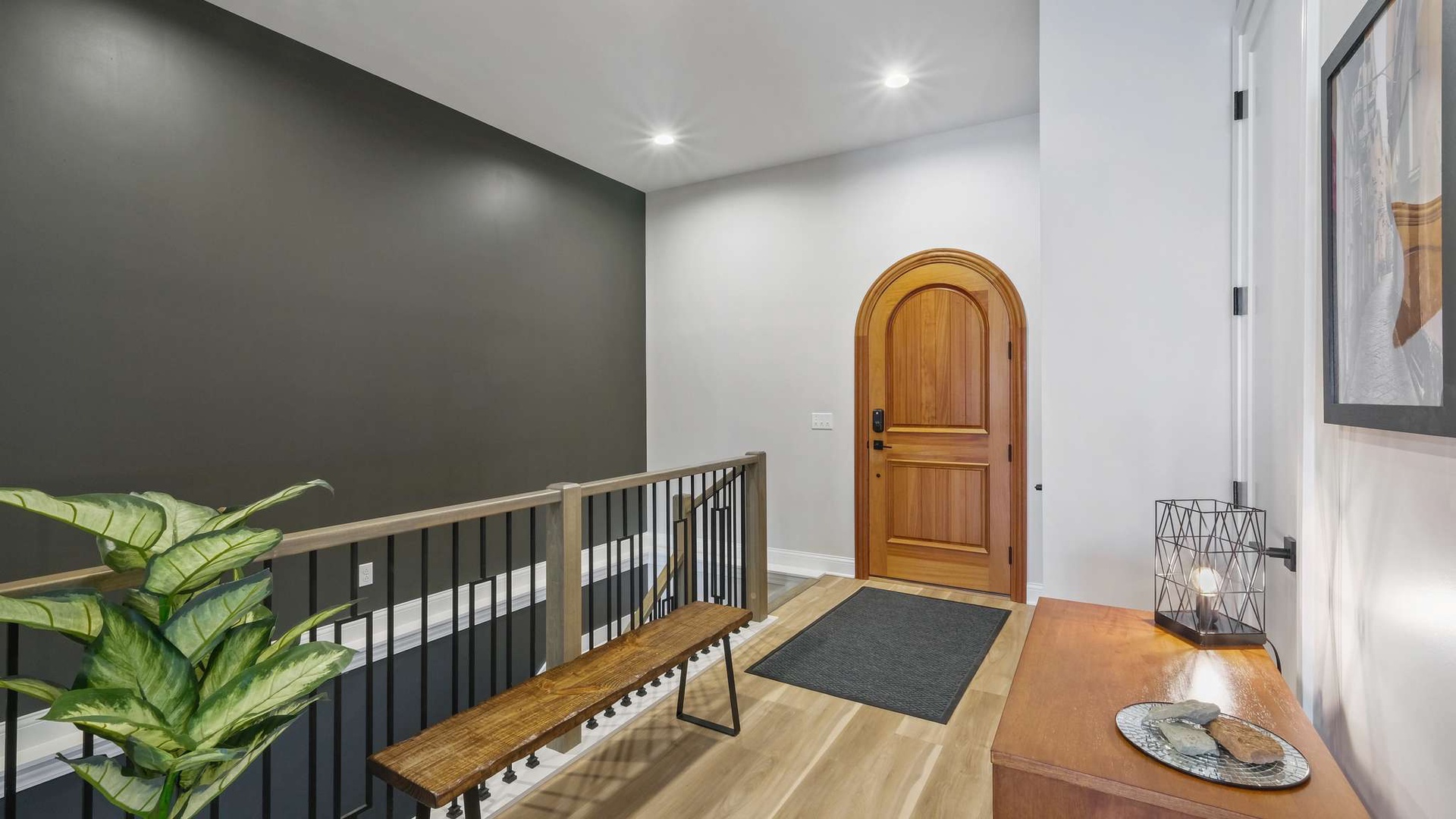 Arrive at your stylish entryway featuring warm wood accents, modern design, and a welcoming atmosphere that sets the tone for comfort.