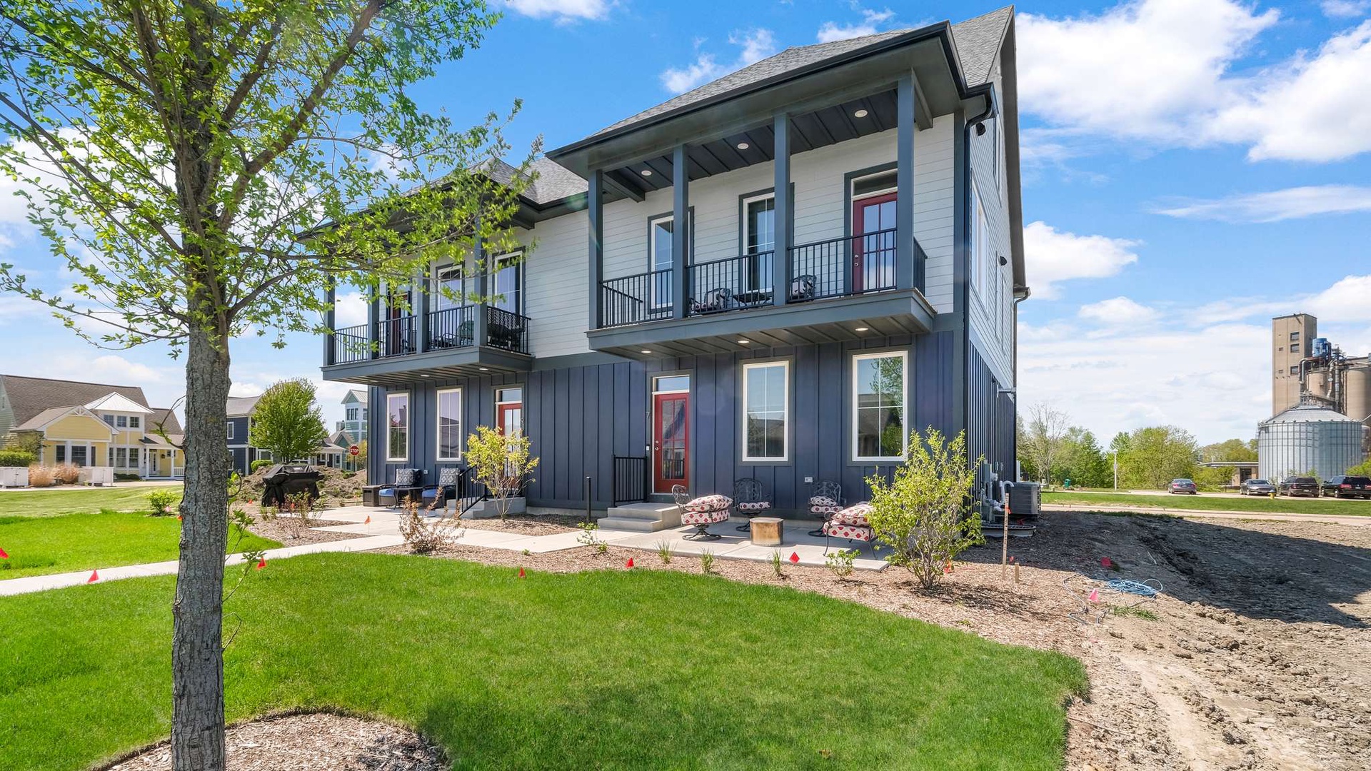 Modern two-story property with spacious balconies and beautifully landscaped grounds in a peaceful neighborhood setting.