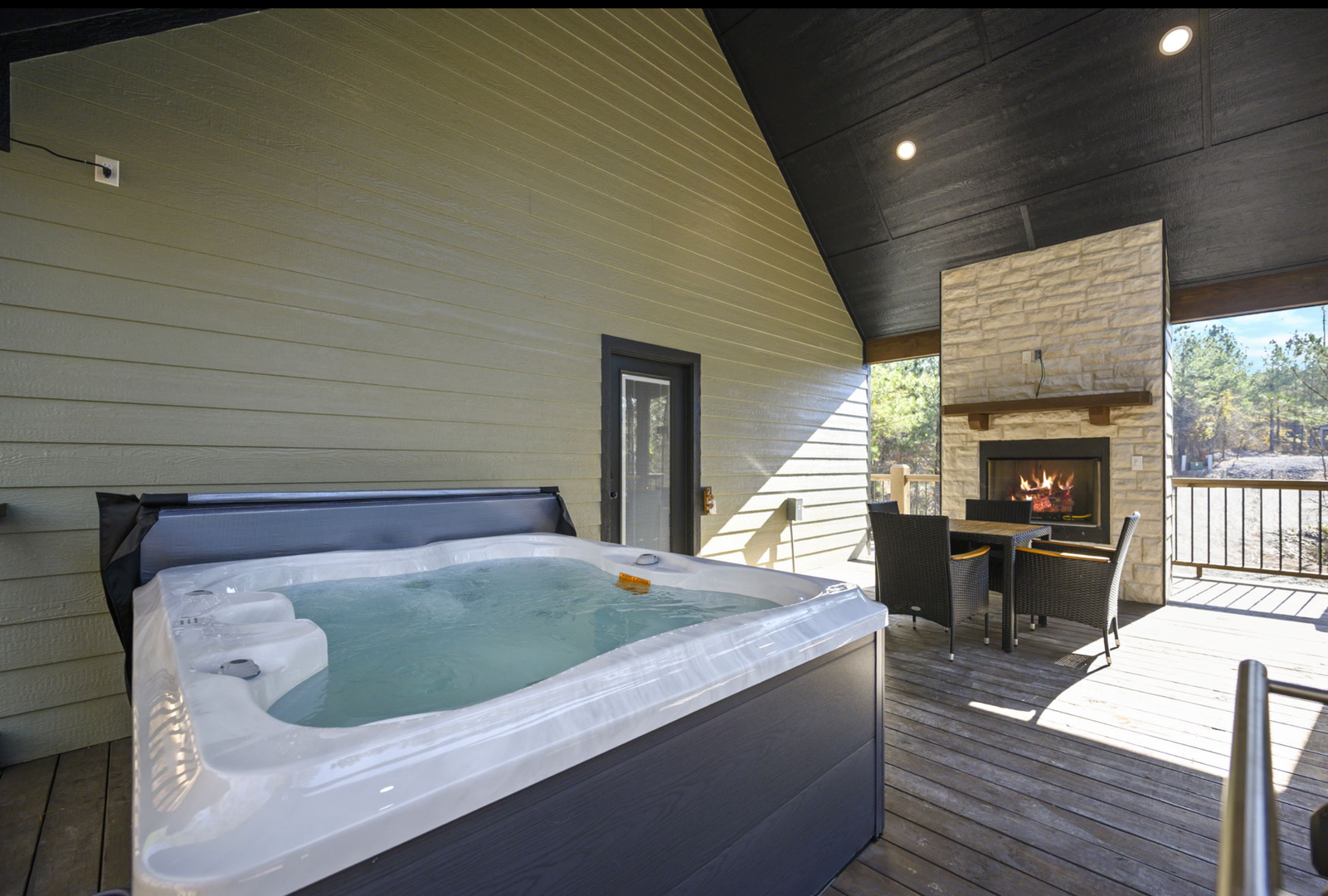 Soak in your private hot tub while the fireplace crackles nearby, creating the perfect outdoor retreat for relaxation.