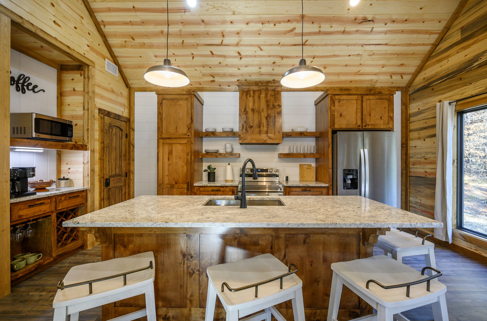 You'll love cooking in this rustic kitchen with exposed beams, granite counters, and modern appliances that blend mountain charm with convenience.