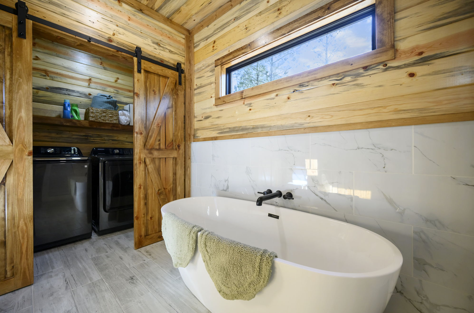 Sink into pure relaxation in your private soaking tub surrounded by warm wood and natural light streaming through the window.