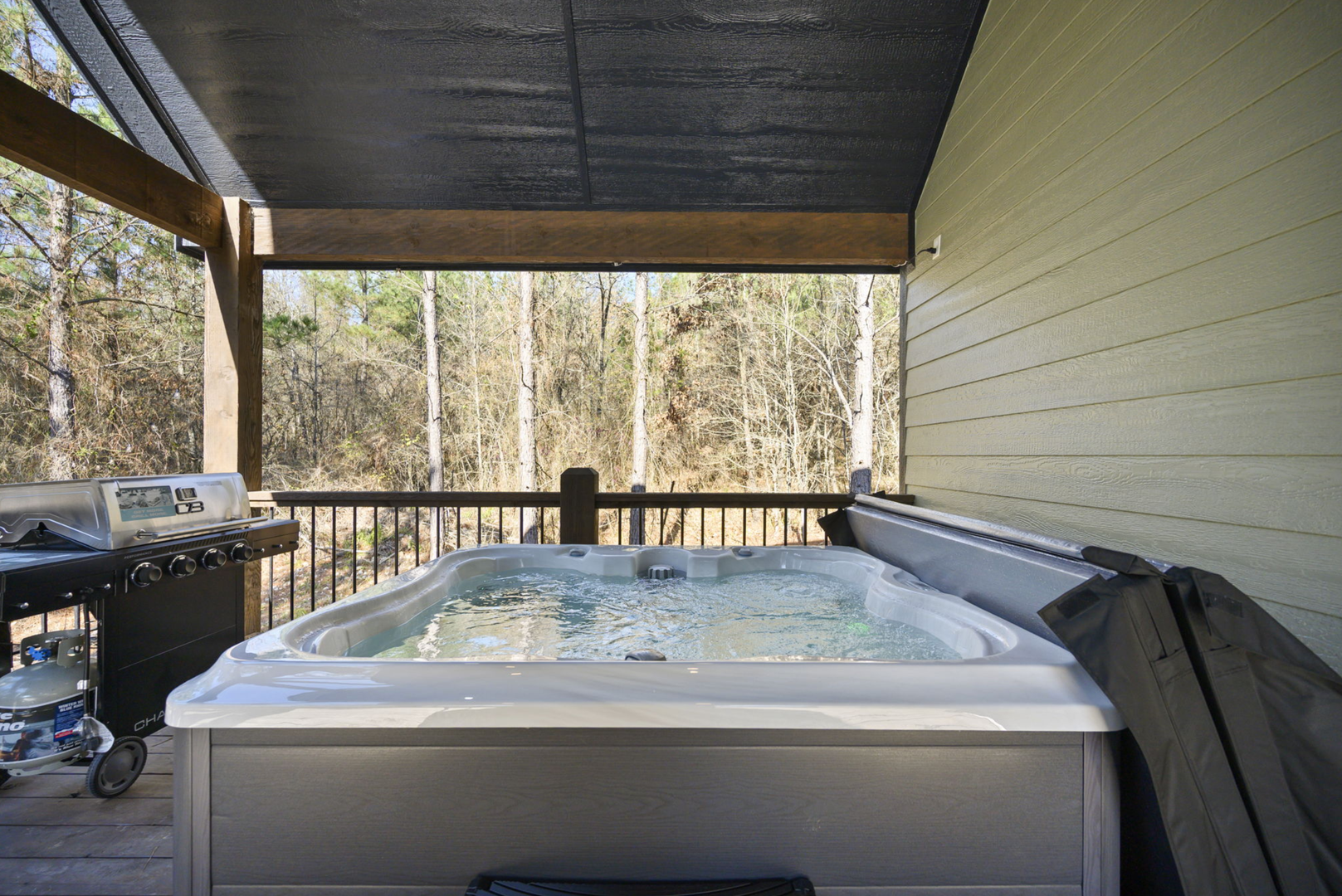 Soak your cares away in this covered hot tub while enjoying peaceful woodland views.
