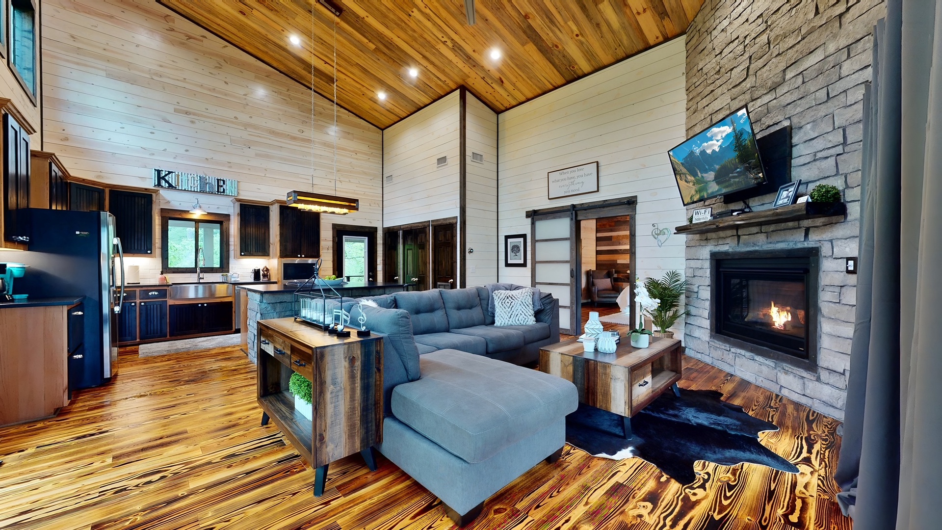 Unwind in your open-concept retreat with soaring wood ceilings, cozy fireplace, and modern comforts that blend rustic charm with contemporary style.