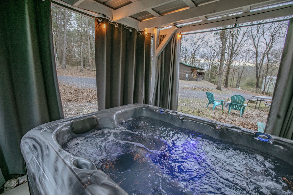 Soak in your private hot tub while gazing at the peaceful wooded landscape through floor-to-ceiling windows.