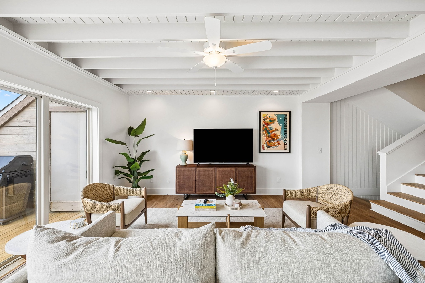 Unwind in your bright, airy living room where natural light and coastal charm meet. Sink into the plush sofa, enjoy your favorite shows, and step out to the patio for fresh breezes.