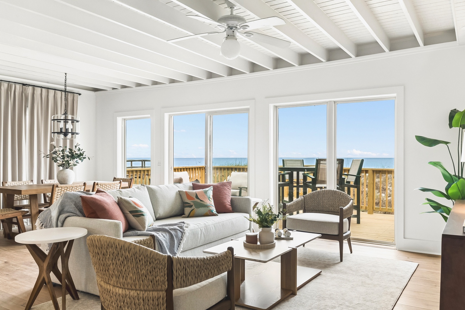 Unwind in this bright, open living space where panoramic ocean views through expansive windows create a serene coastal retreat. Sink into the plush sofa and let the calming blues wash over you.