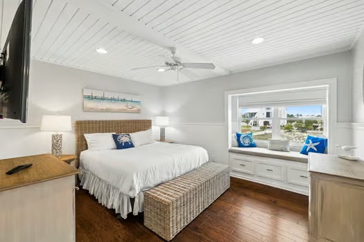 Your serene bedroom retreat features a plush king bed, coastal charm, and a cozy window seat overlooking the neighborhood—perfect for morning coffee or winding down.