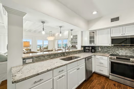 Your fully equipped kitchen features granite counters, modern appliances, and an open layout with stunning ocean views—perfect for preparing meals while soaking in the coastal scenery.