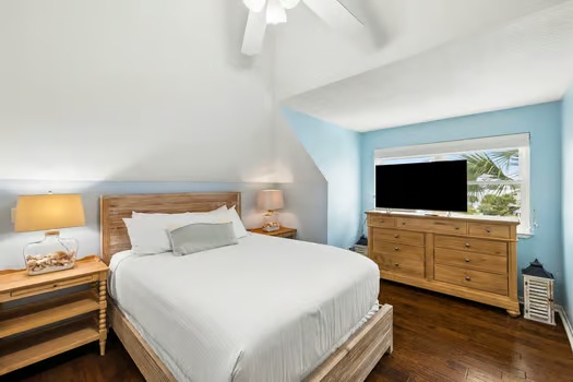 Unwind in your serene bedroom retreat featuring crisp linens, natural wood furnishings, and soft coastal tones that invite peaceful nights and lazy mornings.