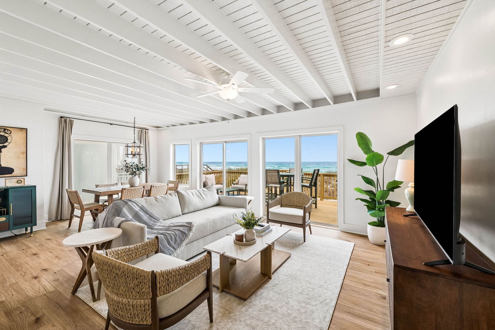 Relax in your bright, airy living space with sweeping ocean views just beyond your deck. White beamed ceilings and coastal-inspired décor create a serene retreat where your beach escape begins.