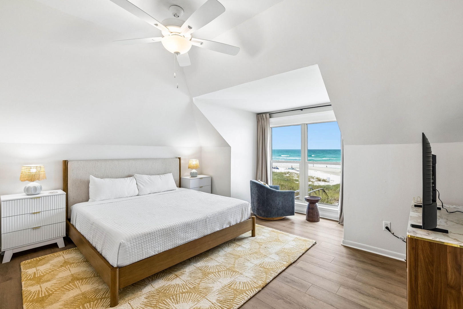 Wake up to breathtaking ocean views from your cozy bedroom retreat. Crisp linens, a ceiling fan for comfort, and direct beach access make this your perfect coastal escape.