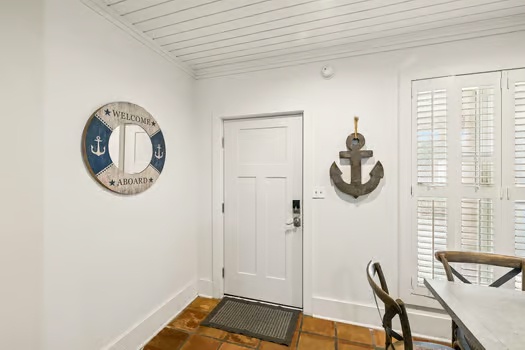 Step into your coastal retreat with charming nautical décor welcoming you home. The bright, airy entryway with shiplap ceilings sets a relaxed, beach-inspired tone from the moment you arrive.