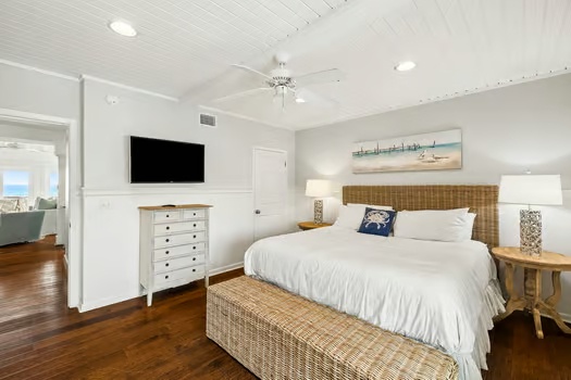 Drift off in your serene coastal bedroom, where a plush king bed, natural textures, and soothing decor create the perfect retreat after a day of beach adventures.