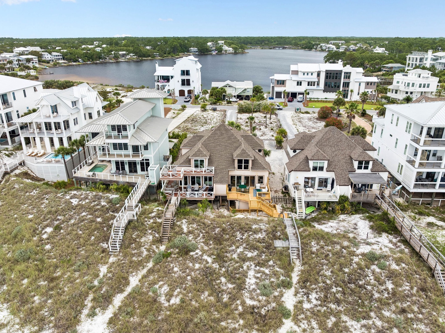 This waterfront community features beach-style homes with direct water access and coastal landscaping, set in a picturesque neighborhood with lake views and natural surroundings.