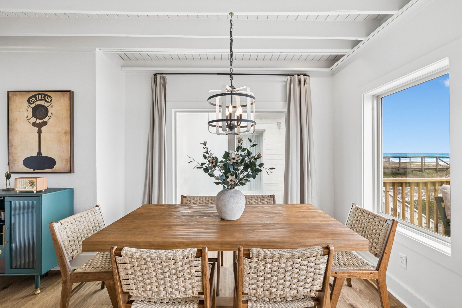 Gather around this beautiful dining table where shared meals become treasured memories, with coastal views adding natural beauty to your experience.