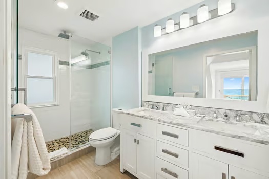 Step into your serene spa-like bathroom with dual vanities, a refreshing walk-in shower, and calming coastal tones that make every morning feel like a getaway.