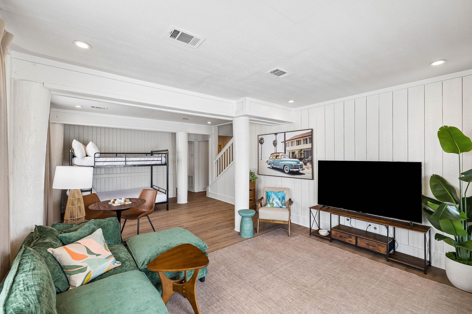 Unwind in your stylish living space with a plush sofa, smart TV, and cozy sleeping nooks—perfect for relaxing after exploring.