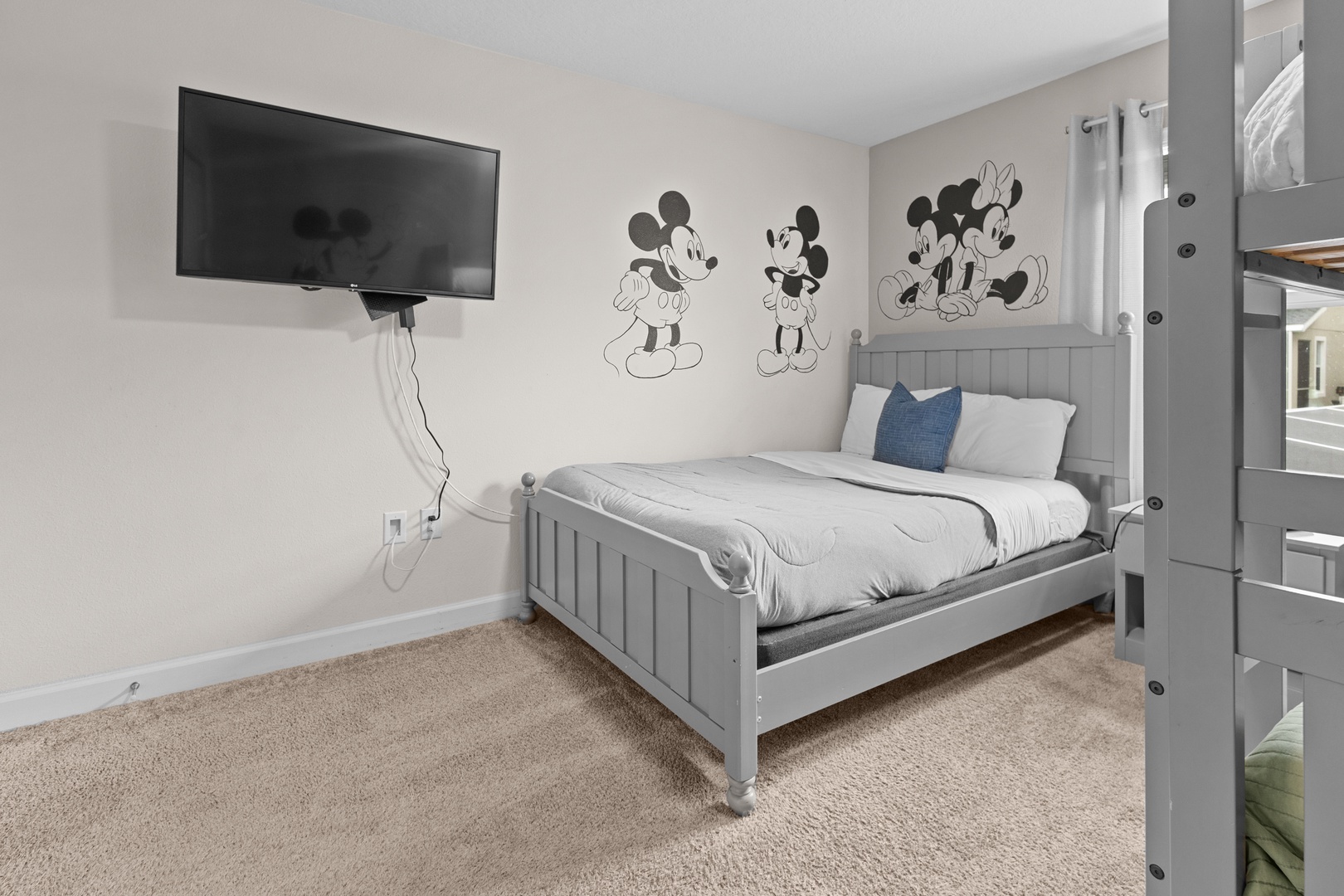 Your kids will love this magical bedroom with Disney characters on the walls, cozy beds, and their own TV for movie nights.