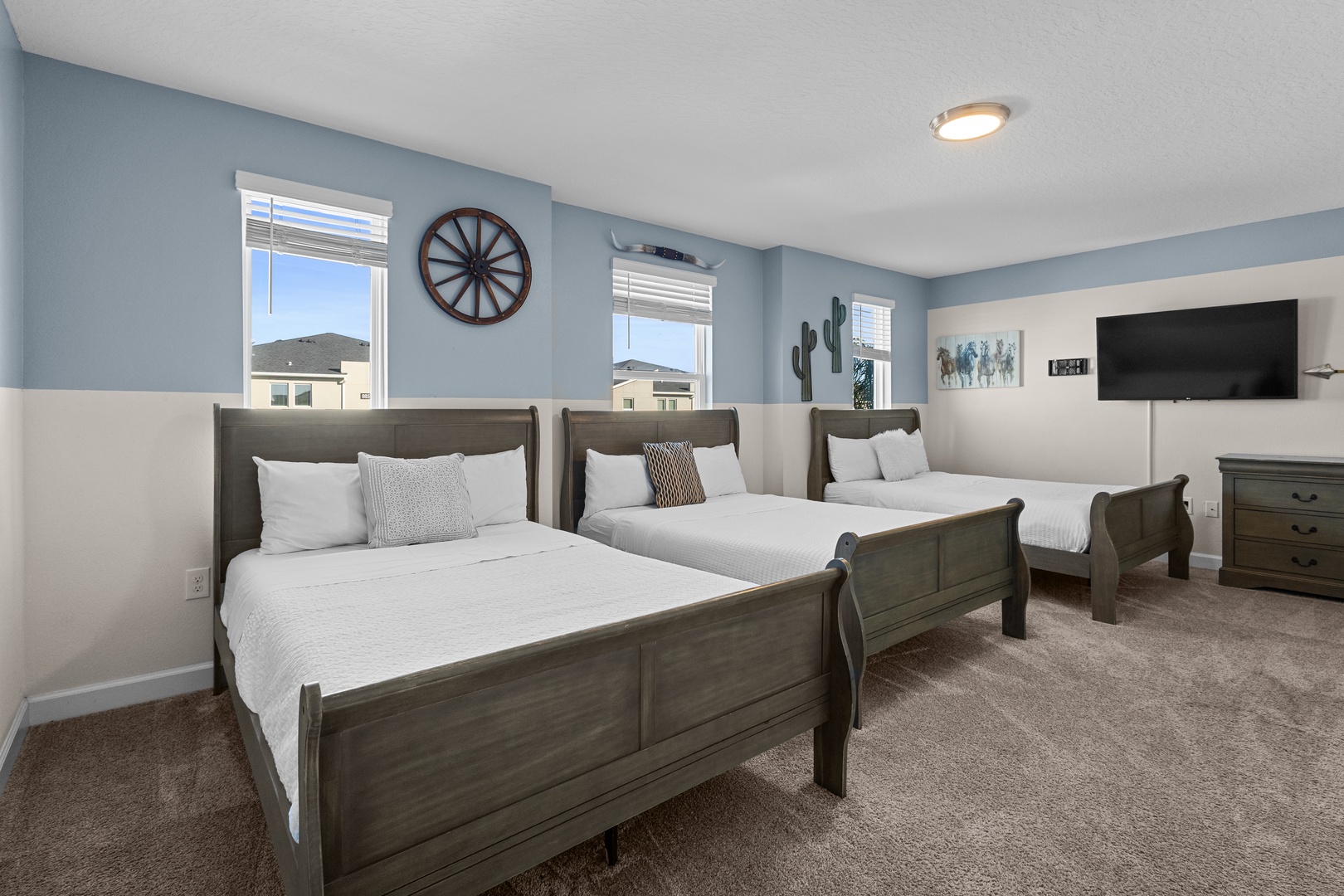 Relax in your spacious western-themed bedroom with three comfortable beds, perfect for families or groups sharing memorable moments together.
