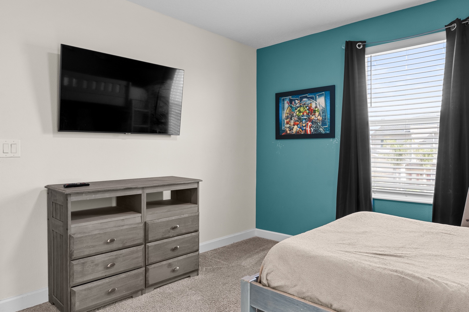 Unwind in your bright bedroom with wall-mounted TV, ample dresser storage, and blackout curtains for perfect rest.