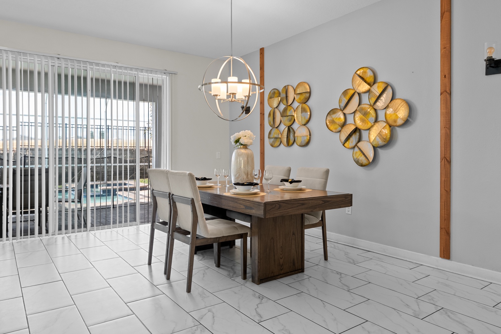 Your stylish dining space features modern furnishings and elegant decor, perfect for memorable meals with pool views through expansive windows.