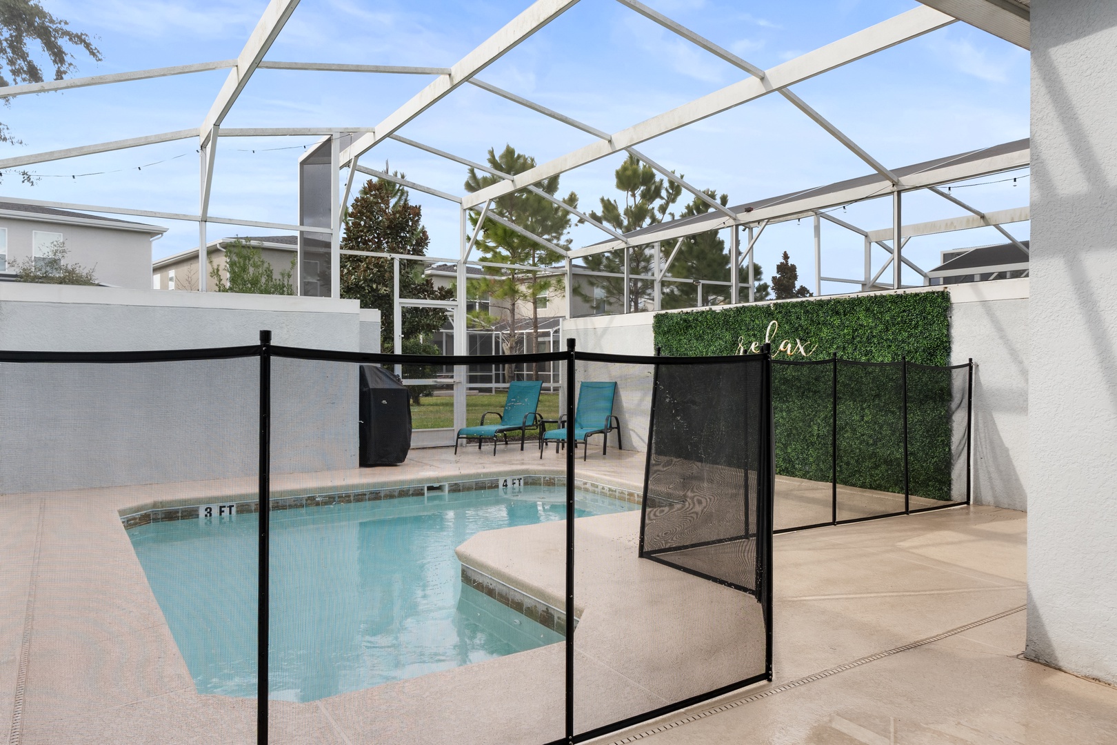 Dive into your private screened pool where turquoise waters await beneath sunny Florida skies, complete with safety fencing for peace of mind.