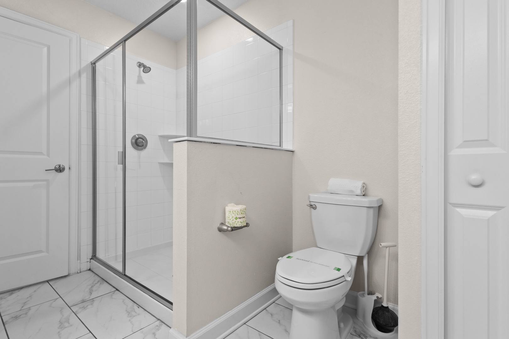 Your private bathroom features a spacious glass-enclosed shower and modern fixtures, creating a clean, comfortable space for your daily routine.