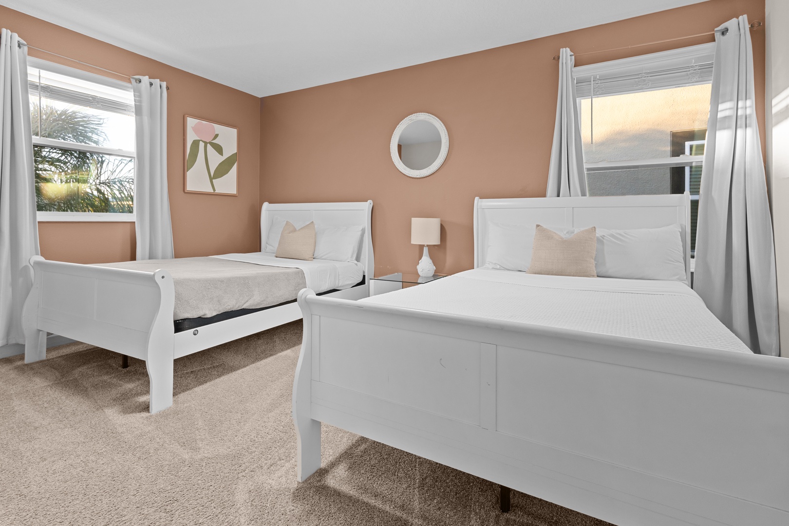 Wake up refreshed in your peaceful twin bedroom with crisp white linens and warm natural light streaming through dual windows.