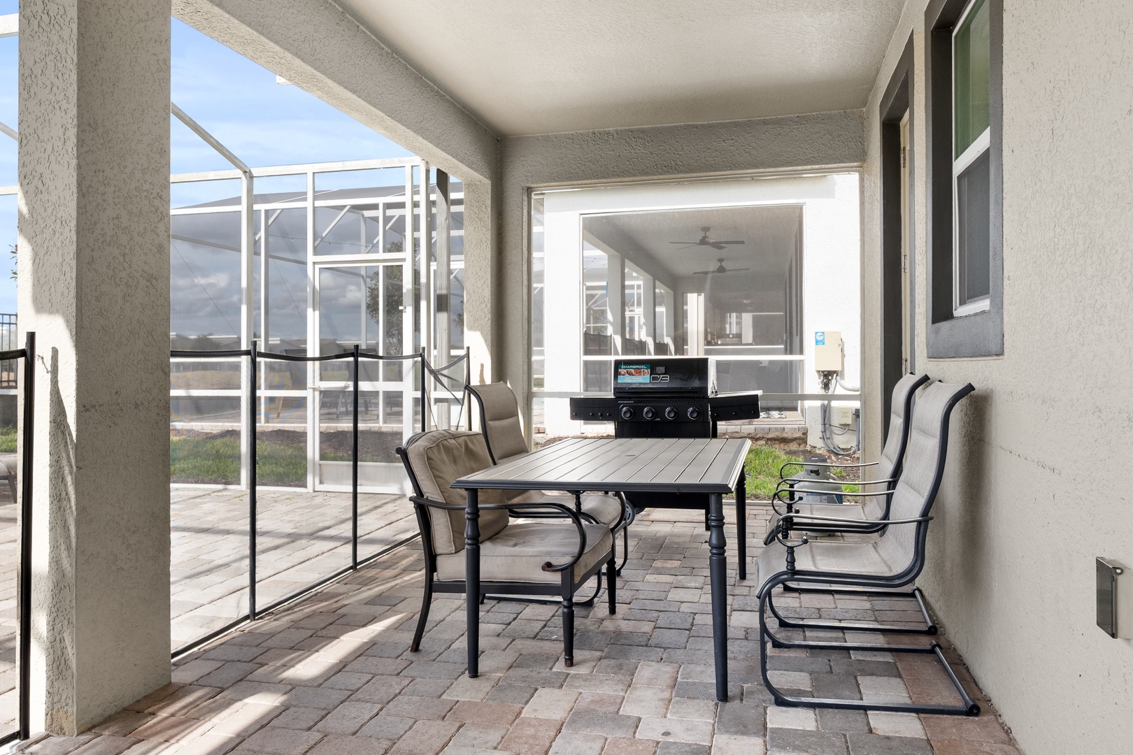 Your covered patio offers peaceful dining with a gas grill nearby for easy outdoor cooking.