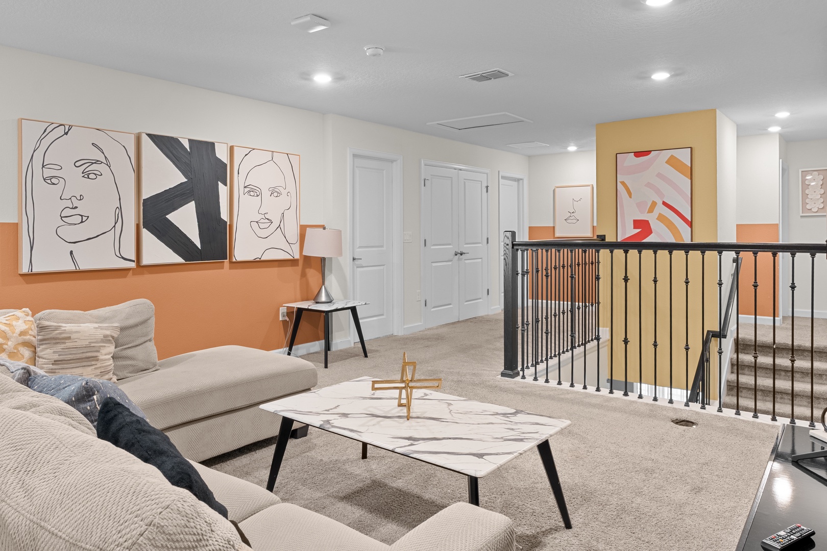 Relax in your stylish upstairs lounge with modern art, plush seating, and thoughtful design touches that create the perfect retreat.