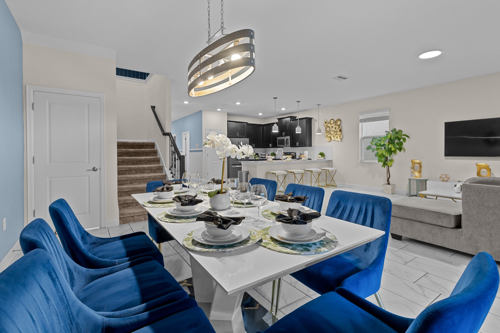 Gather around your elegant dining table with plush blue velvet chairs for memorable meals together.