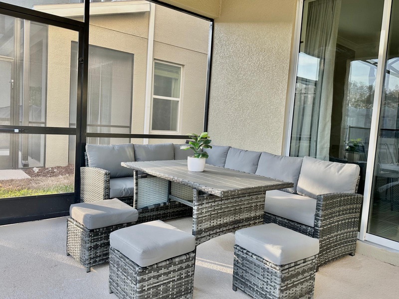 Your private enclosed lanai offers a perfect retreat with comfortable sectional seating and dining space for peaceful outdoor relaxation.