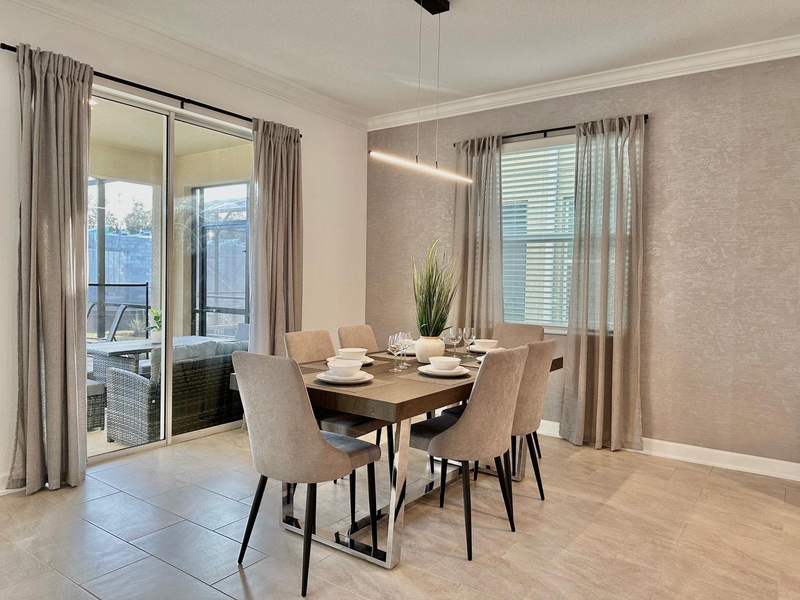 Gather around your elegant dining table for six, where modern pendant lighting creates the perfect ambiance for memorable meals together.