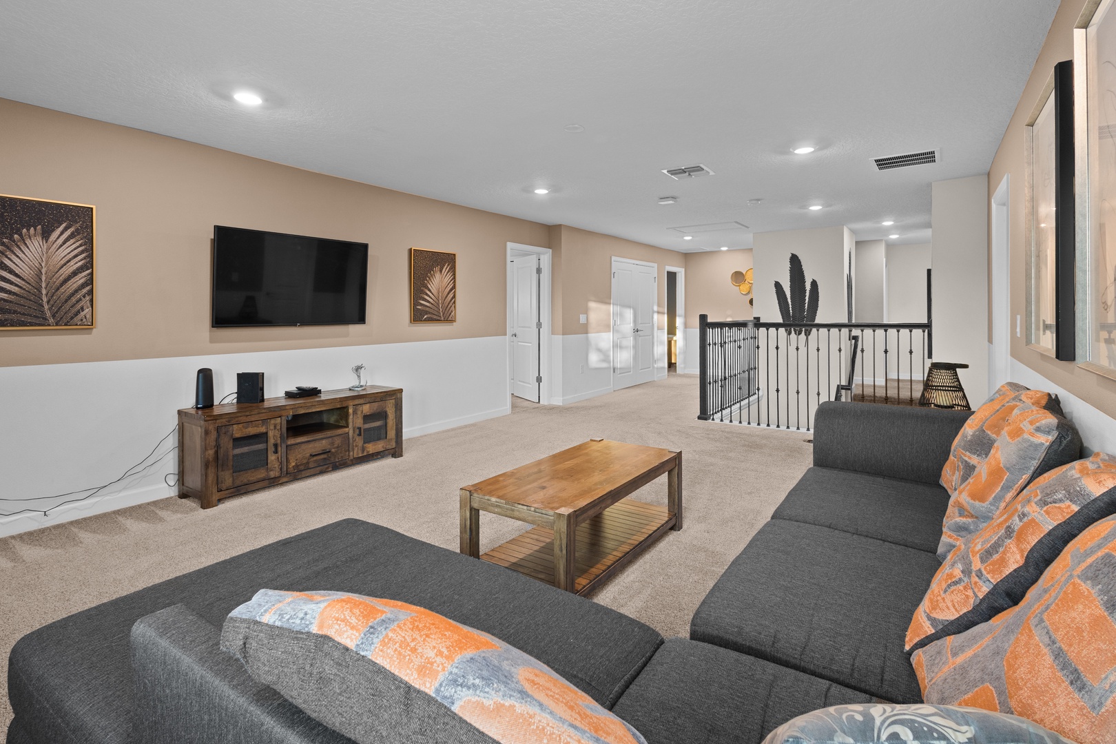 Your spacious loft lounge features plush seating, warm wood accents, and entertainment center - perfect for unwinding with loved ones.